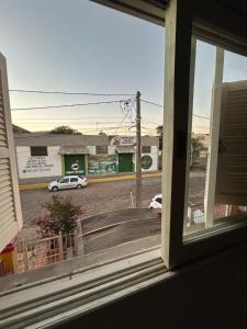 a view from a window of a street with a car at Casa temporada SG in São Gabriel +1 photo