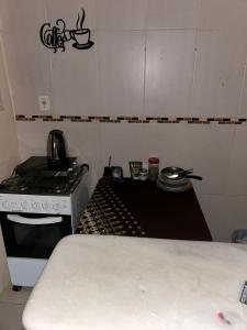 a kitchen with a stove and a stove top oven at Casa temporada SG in São Gabriel