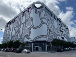 a building with a painting on the side of it at OQP Hostel Miami in Miami