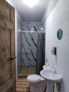 a bathroom with a toilet and a sink at Mariposa Drake in Drake