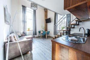 a living room with a couch and a sink in a room at The LOFT Ljubljana in Ljubljana