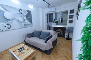 a living room with a couch and a table at GAMA Apartments in Bitola