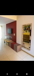 a living room with a mirror and a table at casas praias familiar in Piçarras
