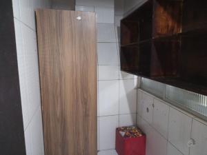 a bathroom with a wooden cabinet and a red box at casas praias familiar in Piçarras
