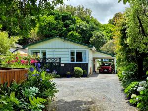 a house with a car parked in the driveway at Waikanae Accommodation Studio B&B in Waikanae