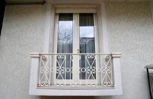 a balcony of a building with a window at Hortus Hotel Tirana in Tirana