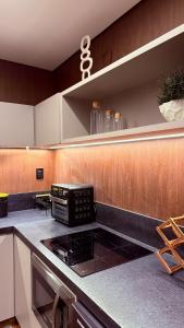 a kitchen with a stove and a counter top at Flat Vinhedo in Montes Claros +27 photos