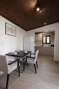 a dining room with a table and chairs and a kitchen at Raise Polydrosos Traditional Getaway in Polydrossos