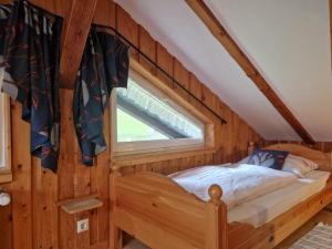 a bedroom with a bed in a room with a window at Neubert in Breitenbrunn