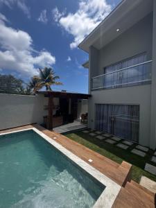 a swimming pool in front of a house at Casa Top in Porto Seguro
