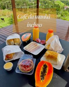 a table topped with different types of bread and fruit at Cupulesantorini in Santa Isabel