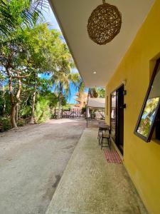 a patio with a table and chairs and trees at Casa Tio 1,quiet ground floor apartment in El Cuyo