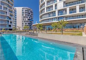 a swimming pool in front of two tall buildings at The Solace in Midrand