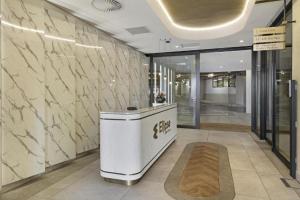 a lobby with a reception desk in a building at The Solace in Midrand +30 photos