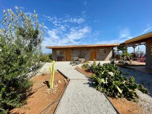 a house with a patio and plants in front of it at Sn Tony Hotel & Spa in Valle de Guadalupe