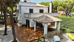 a white house with a gazebo in front of it at Coreto's Village in Praia Verde