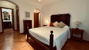 a bedroom with a large bed in a room at Coreto's Village in Praia Verde +112 photos