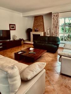 a living room with a couch and a table at Coreto's Village in Praia Verde