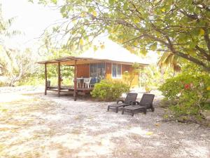 a small house with two chairs and a porch at MONITA VILLA Rangiroa in Tiputa