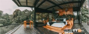 a bedroom with a bed and a table at Bio Habitat Hotel, AKEN SOUL Collection in Armenia
