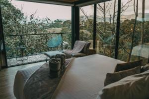 a room with a bed and a view of the forest at Bio Habitat Hotel, AKEN SOUL Collection in Armenia +79 photos
