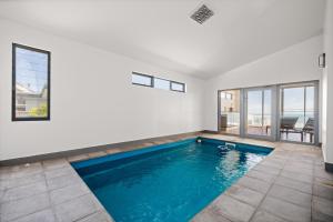 a swimming pool in a house with a view at Cliff Top Retreat in San Remo