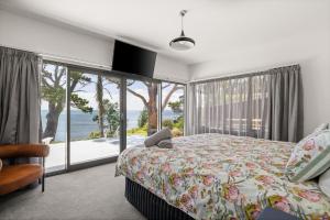 a bedroom with a bed and a view of the ocean at Cliff Top Retreat in San Remo +29 photos