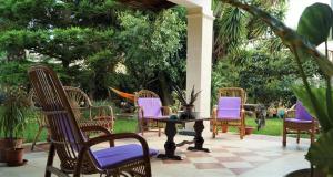 a group of chairs and a table on a patio at Villa Elide in Ginosa Marina