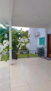 an empty room with a large room with trees in it at Casa confortável com garagem coberta in Primavera do Leste
