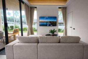 a living room with a couch and a table at AVA Aurora Villa in Wok Tum