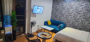 a living room with a blue couch and a table at Mardley Suites in Nairobi