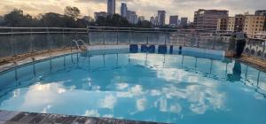 a swimming pool with the city in the background at Mardley Suites in Nairobi