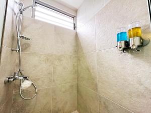 a shower stall in a bathroom with a window at Private beach access, fiber optic internet & parking in Punaauia +43 photos