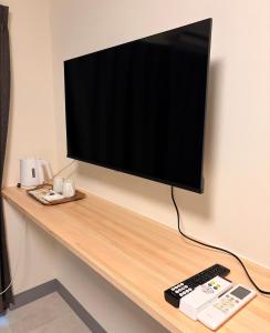 a flat screen tv sitting on top of a desk at hotel LUNA STELLA in Sendai