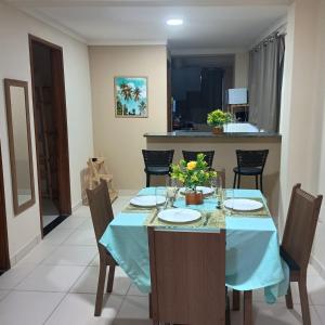 a dining room with a blue table and chairs at Paim`s Village Itacaré in Itacaré