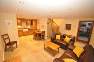 a living room with a couch and a table at Hastings Barn in Bideford