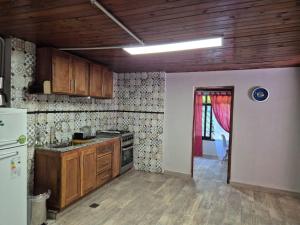 a kitchen with wooden cabinets and a stove top oven at Casa Maipu in Corrientes +5 photos