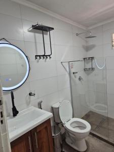 a bathroom with a toilet and a sink and a mirror at Casa Maipu in Corrientes