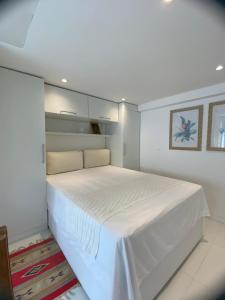 a bedroom with a large white bed in a room at MATER Vila Borges in Rio de Janeiro