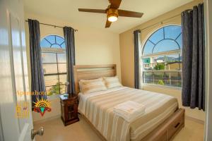 a bedroom with a bed and two windows at Villa Del Sol in Ixmiquilpan