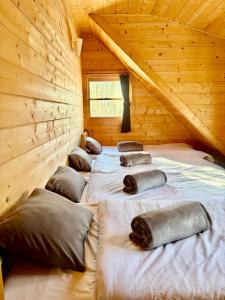 a group of pillows on a bed in a log cabin at Secret Base Mysa シークレットベース ミーサ 星の街399 in Tsumagoi