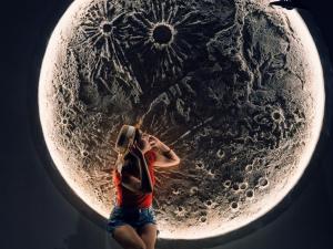 a woman standing in front of a large metal sculpture at abundance okinawa & Kourijima Sauna resort in Kouri