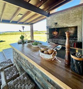a counter with a basket of food and a fireplace at Chacra para 13! A 20min Punta del Este - Starlink in Maldonado