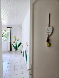 a hallway with a heart sign on the door at Exceptional villa KODEÏA - private spa & panoramic view in Sainte-Marie
