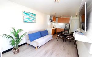 a living room with a white couch and a table at Playa Paraíso Resort in Concón