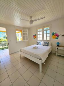 a bedroom with a large bed in a room at Exceptional villa KODEÏA - private spa & panoramic view in Sainte-Marie +20 photos
