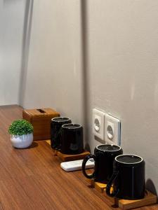 a group of black coffee cups sitting on a table at Wish Uluwatu in Uluwatu