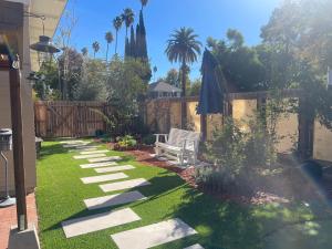 a garden with a bench and a fence at Suite in Downtown Riverside in Riverside
