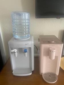 a blender and a water maker on a table at Suite in Downtown Riverside in Riverside