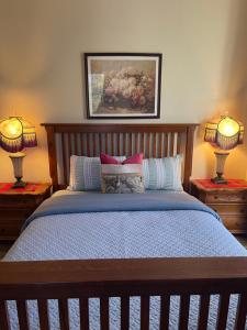 a bedroom with a bed with two lamps on two tables at Suite in Downtown Riverside in Riverside